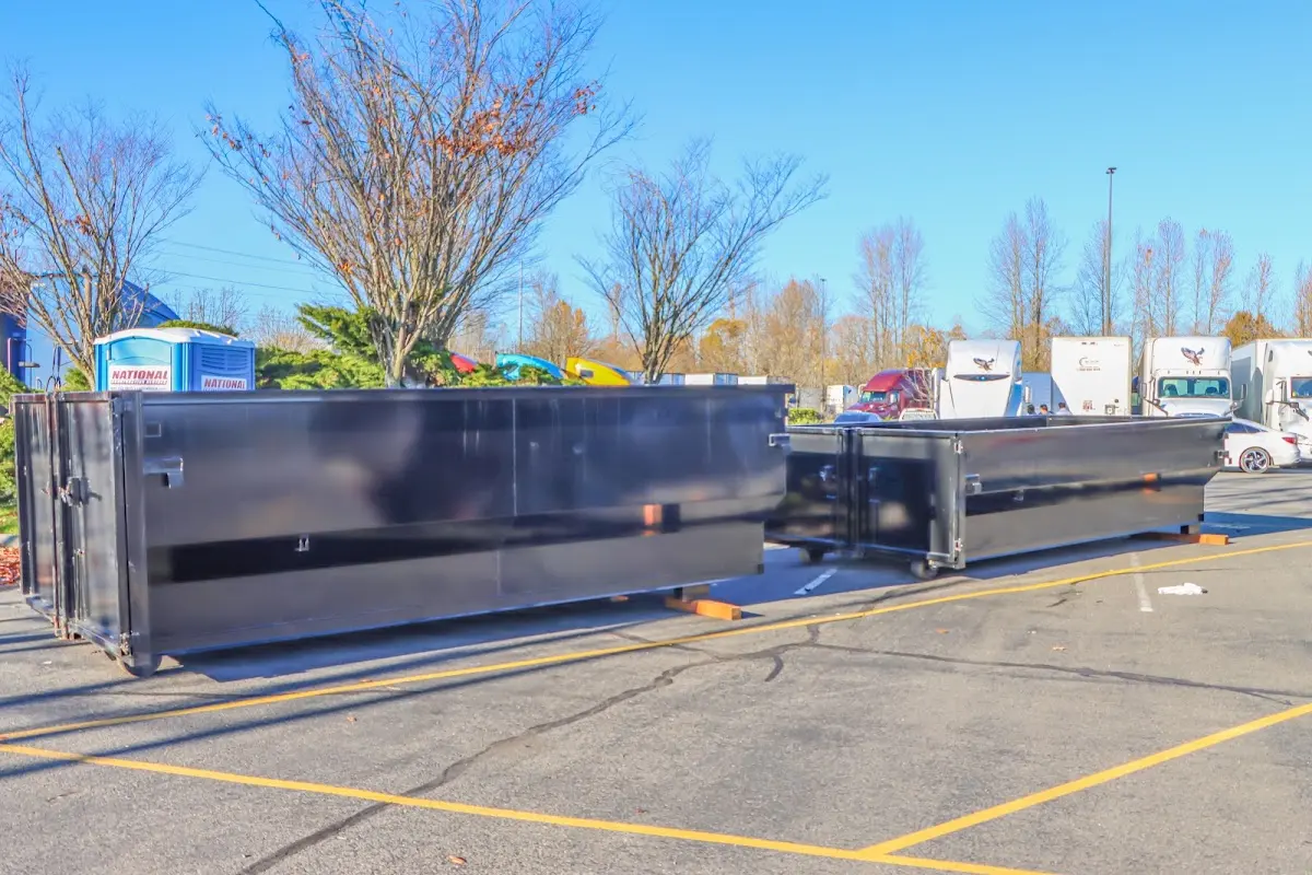 Professional dumpster rental service with roll-off container on residential driveway in Cottonwood Heights